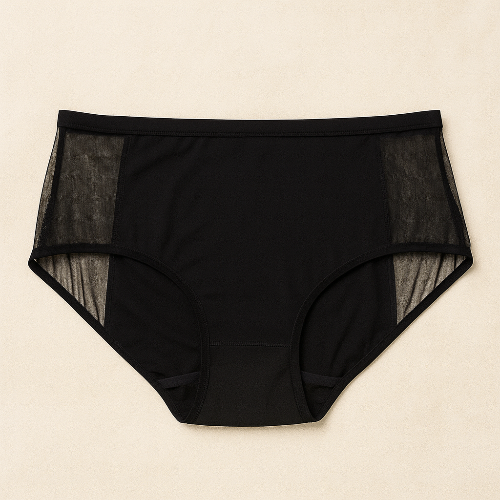 Black high-waisted underwear with mesh panels on a beige background