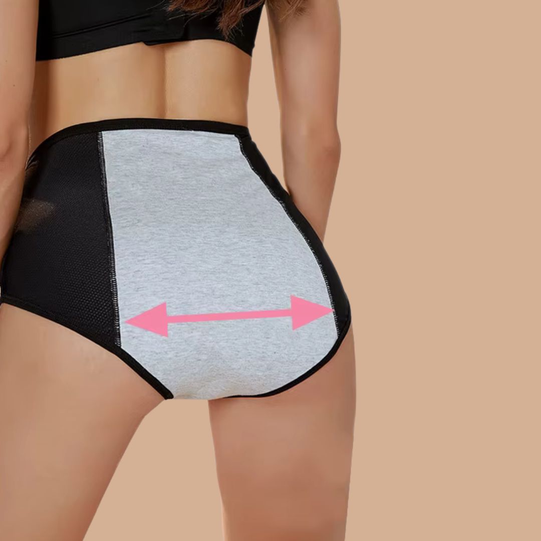 Person wearing a black and gray compression garment with pink arrows indicating measurement on a beige background