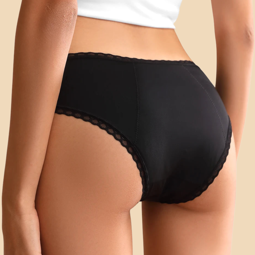 Black underwear worn by a person on a beige background